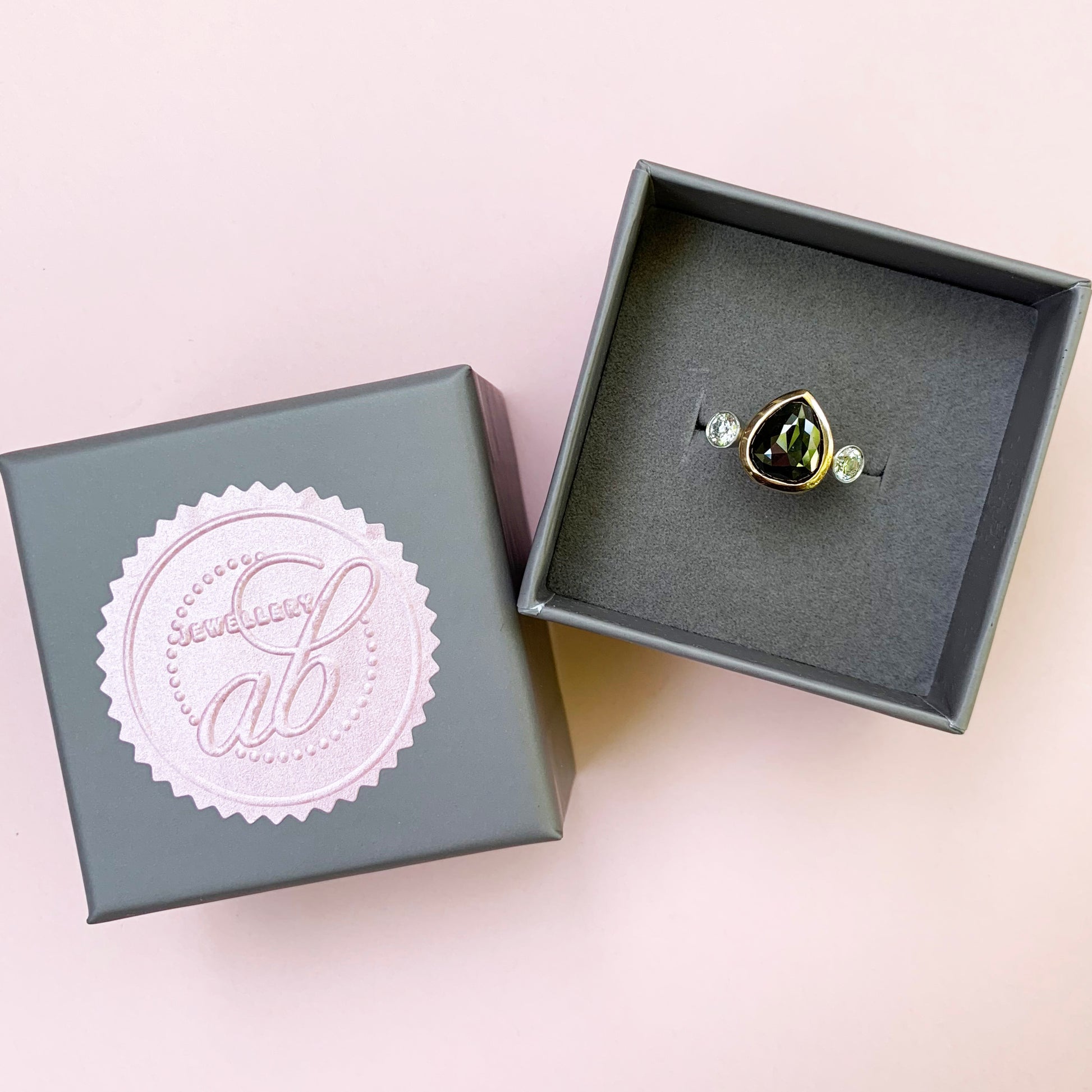 rose cut black diamond ring, 18ct rose gold diamond ring, rose gold ring, black diamond ring with white diamonds either side, black diamond ring, 18ct rose gold diamond ring